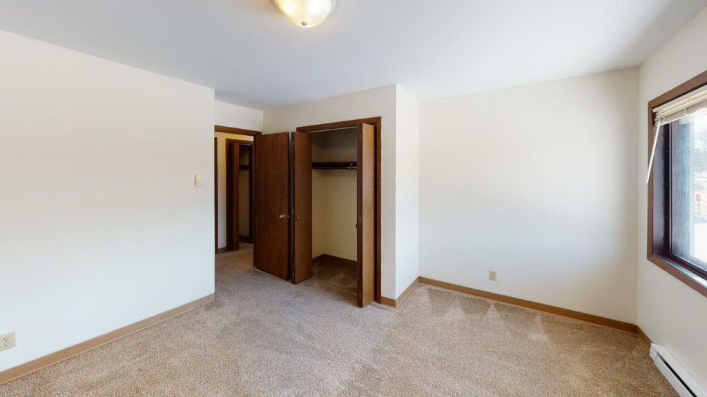 carpeted bedroom with closet