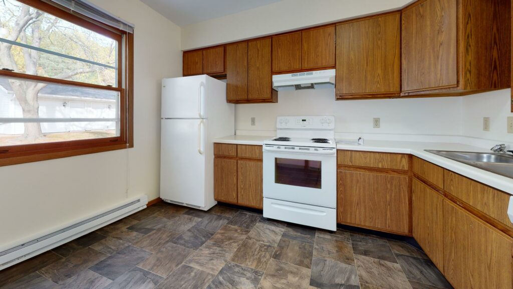 tiled kitchen with white appliances