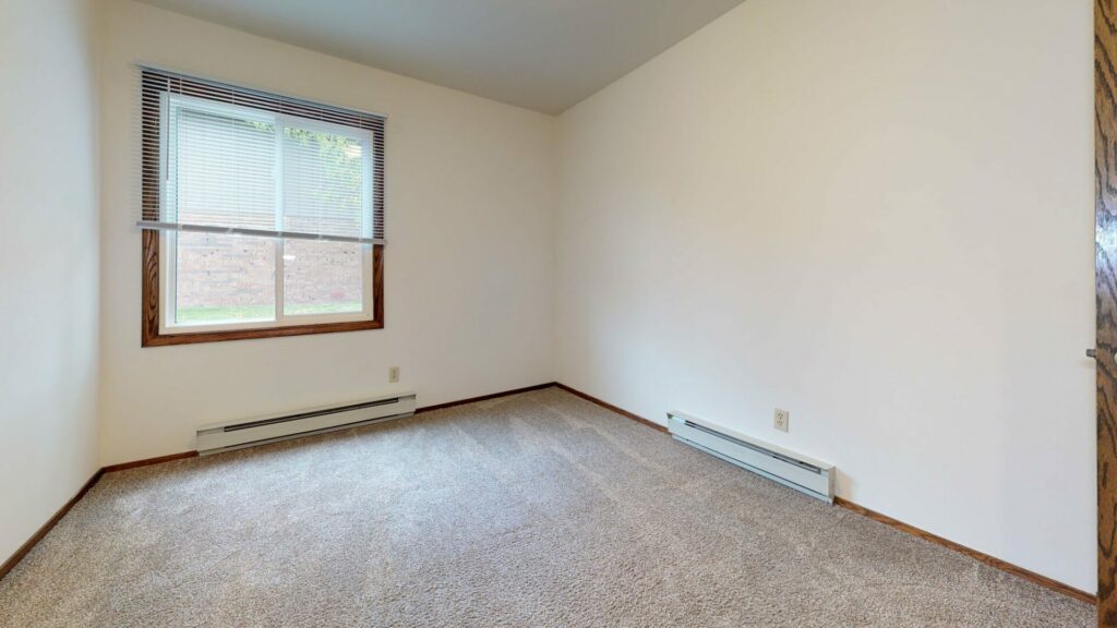 carpeted bedroom with baseboard heating
